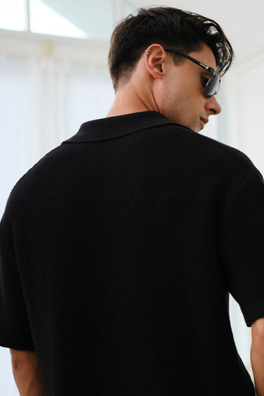 Black knit textured polo T-shirt by Bonkers Corner, close-up of fabric and collar, casual men's fashion top.
