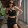 Black long slit skirt by Bonkers Corner, featuring a high waist and flowing fabric, perfect for stylish casual or dressy looks.