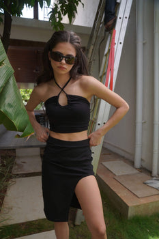 Black long slit skirt by Bonkers Corner, featuring a high waist and flowing fabric, perfect for stylish casual or dressy looks.