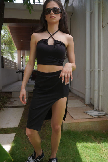 Black long slit skirt from Bonkers Corner featuring a high waist and flowing fabric, perfect for stylish, edgy outfits.