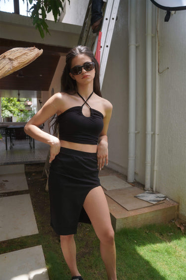Black long slit skirt by Bonkers Corner, showing lightweight fabric and high slit detail, styled for a trendy look.