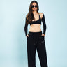 Black loose fit joggers from Bonkers Corner with elastic waistband and relaxed style, shown laid flat.