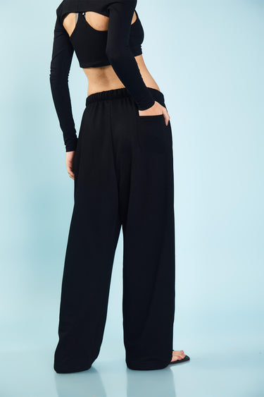 Black loose fit joggers from Bonkers Corner, with a relaxed style and elastic waistband, shown on a model.