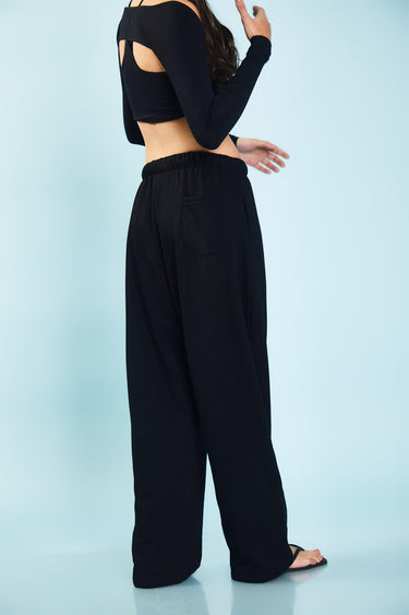 Black loose fit joggers by Bonkers Corner displayed on a model, showcasing comfortable, casual athletic wear.