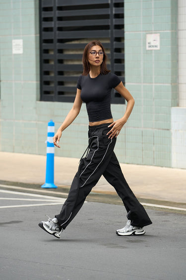 Black polyamide fitted T-shirt by Bonkers Corner, showcasing a close-up of the sleek, form-fitting design and smooth fabric.