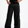 Black sporty deconstructed loose pants by Bonkers Corner with relaxed fit and casual style, shown on a neutral background.