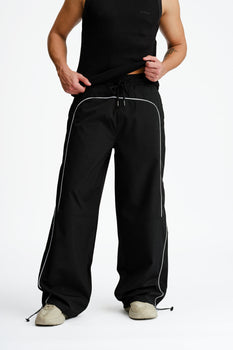 Black sporty deconstructed loose pants by Bonkers Corner, featuring a relaxed fit and casual style.