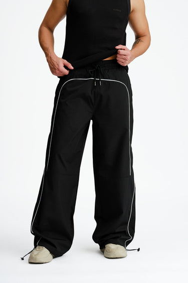 Black sporty deconstructed loose pants by Bonkers Corner, featuring a relaxed fit and casual style.