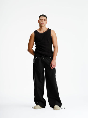 Black sporty deconstructed loose pants from Bonkers Corner, featuring a relaxed fit and casual style.