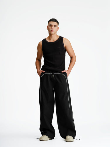 Black sporty deconstructed loose pants by Bonkers Corner with relaxed fit and casual style, shown on a model.