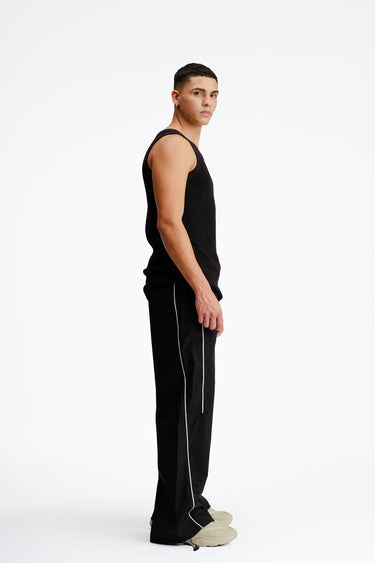 Black sporty deconstructed loose pants from Bonkers Corner, showcasing relaxed fit and stylish design with casual, comfortable fabric.