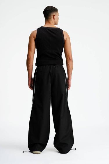 Black sporty deconstructed loose pants by Bonkers Corner, relaxed fit with stylish detailing and casual design.