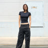 Black sporty deconstructed loose pants by Bonkers Corner, featuring a relaxed fit and casual athletic style.