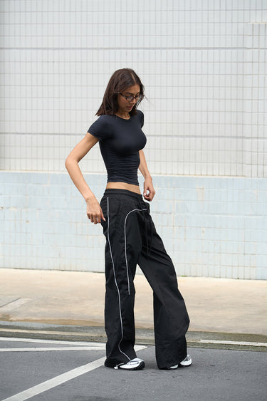 Black sporty deconstructed loose pants by Bonkers Corner, featuring relaxed fit and casual style.