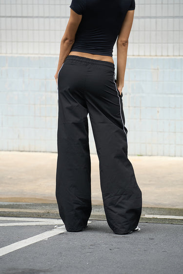 Black sporty deconstructed loose pants by Bonkers Corner, featuring a relaxed fit and casual style.