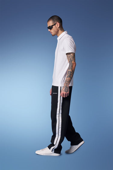 Black sporty straight fit pants by Bonkers Corner, shown in a close-up image highlighting the waistband and fabric texture.
