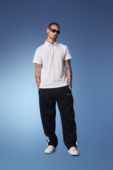 Black sporty straight fit pants by Bonkers Corner shown on a model, featuring a comfortable, casual design for active wear.