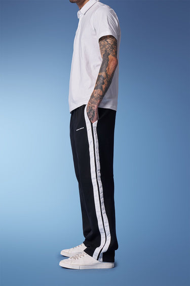 Black sporty straight-fit pants from Bonkers Corner shown on a model, featuring a comfortable fit and modern athletic style.