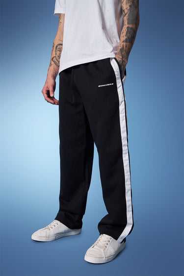 Black sporty straight fit pants by Bonkers Corner, shown on a model, featuring a sleek design and comfortable fit for active wear.