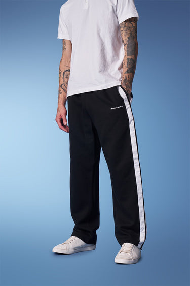Black sporty straight fit pants from Bonkers Corner shown on a model, featuring a comfortable athletic style.