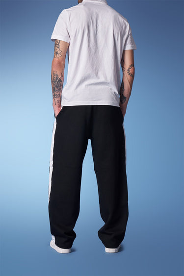 Black sporty straight fit pants by Bonkers Corner, shown on a model, featuring a comfortable athletic style and slim straight cut.