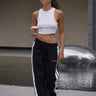 Black sporty straight fit pants by Bonkers Corner, shown with elastic waistband and casual style in a product image.