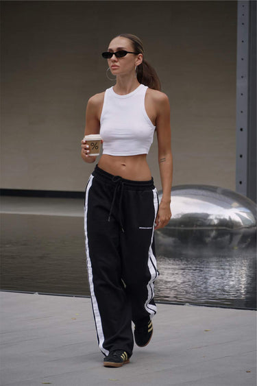 Black sporty straight fit pants by Bonkers Corner, shown with elastic waistband and casual style in a product image.
