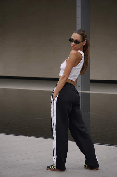 Black sporty straight fit pants by Bonkers Corner featuring a sleek design and comfortable fit.