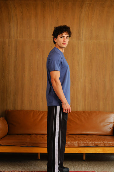 Black tape wide leg joggers by Bonkers Corner, showing the relaxed fit and elastic waist, made from soft, comfortable fabric.