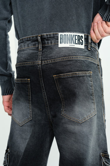 Black wash workwear cargo jeans by Bonkers Corner, featuring multiple pockets and durable denim fabric for rugged style.