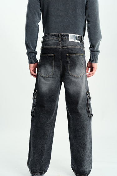 Black wash workwear cargo jeans by Bonkers Corner with multiple pockets and rugged design, displayed on a model.