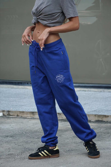 Blue heavyweight joggers by Bonkers Corner featuring a relaxed fit and elastic waistband, shown in a casual streetwear style.