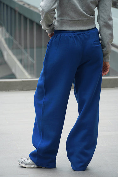 Blue On The Go Joggers by Bonkers Corner, lightweight athletic pants with a relaxed fit, shown on a model.