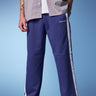 Blue sporty straight fit pants by Bonkers Corner, shown on a model with a casual athletic style.