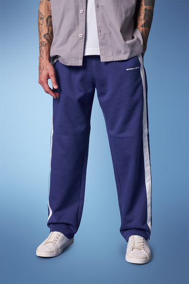 Blue sporty straight fit pants by Bonkers Corner, shown flat with elastic waistband and tapered leg design.