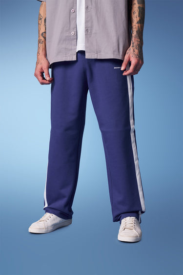 Blue sporty straight fit pants by Bonkers Corner, shown in a close-up image highlighting the casual, athletic style and fabric texture.
