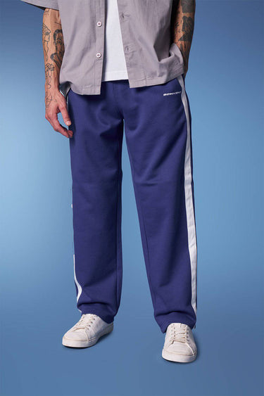 Blue sporty straight fit pants by Bonkers Corner, shown on a model, featuring a casual athletic style and comfortable fit.