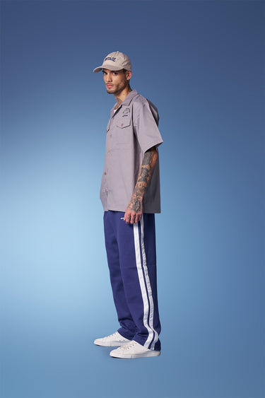 Blue sporty straight fit pants by Bonkers Corner, with a relaxed fit and athletic style, shown on a model.