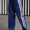 Blue sporty straight fit pants by Bonkers Corner, with a relaxed style and casual design, shown on a model.