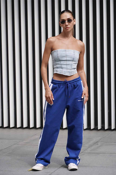 Blue sporty straight fit pants by Bonkers Corner, shown on a model with a casual athletic style.