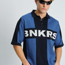 Bonkers Corner BNKRS Legacy Knit Polo shirt in blue, featuring a classic collar and textured knit fabric.