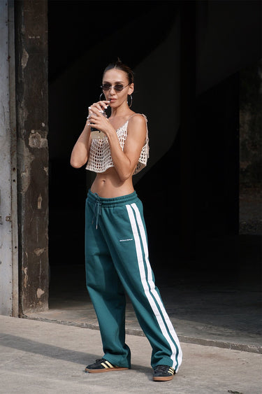 Bottle green sporty straight fit pants by Bonkers Corner displayed on a model, showcasing their casual athletic style and comfortable fit.