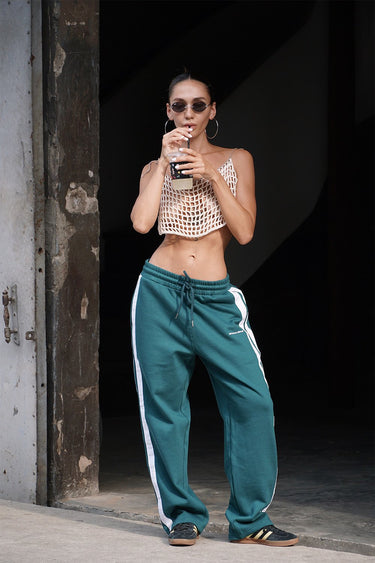 Bottle green sporty straight-fit pants by Bonkers Corner, showing a close-up of the casual, comfortable athletic pants.