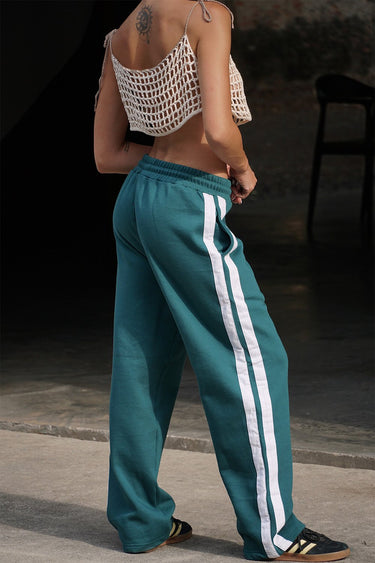 Bonkers Corner bottle green sporty straight fit pants displayed on a model, showcasing casual athletic style and comfortable fit.