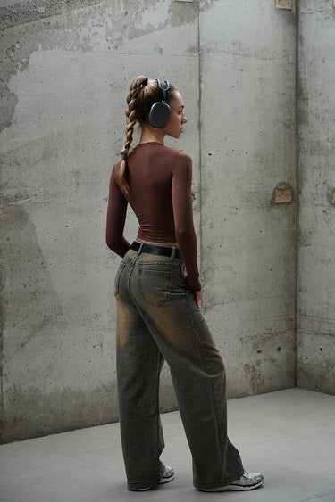 Brown full sleeves polyamide top by Bonkers Corner, close-up of the fitted, smooth fabric and neckline.