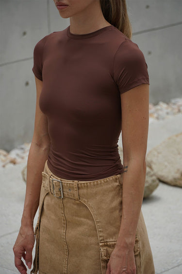 Brown polyamide fitted T-shirt by Bonkers Corner, close-up view showing smooth fabric and tailored fit.