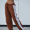 Brown sporty straight fit pants by Bonkers Corner, showcased on a model, featuring a comfortable athletic style and casual fit.