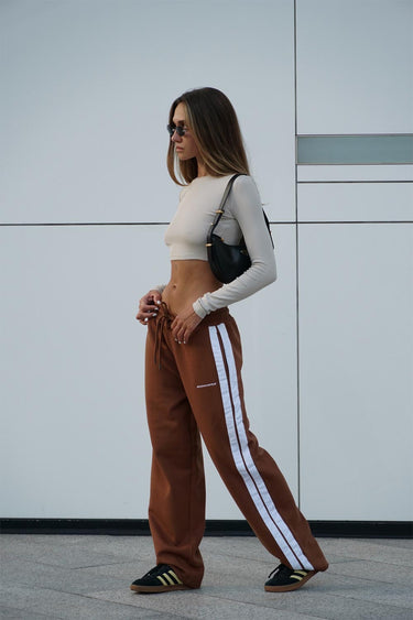 Brown sporty straight fit pants by Bonkers Corner, visible with a relaxed fit and casual style in the image.