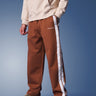 Brown sporty straight-fit pants by Bonkers Corner, shown in a relaxed fit with an elastic waistband and casual style.