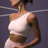 Bonkers Corner bubblegum pink one-shoulder ribbed top displayed on a model, showcasing its trendy design and fitted style.